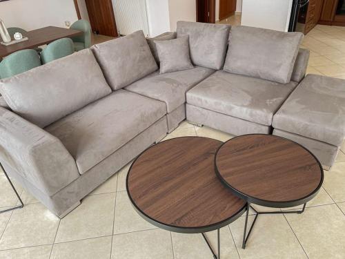 a living room with a couch and two tables at Afroditi's Apartment Superb View in Gythio
