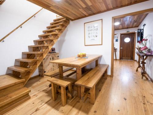 a wooden table and bench in a room with stairs at Castaway in Baleal