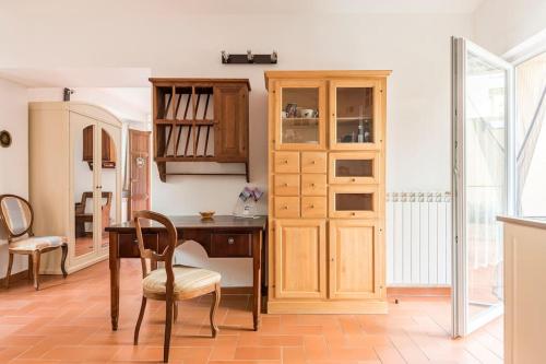 a kitchen with a desk and a table and chairs at DaLu Florence apartment Davide - private car park 15 minutes to the city center in Florence