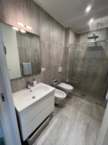 a bathroom with a sink and a toilet and a shower at Maison Mele Ischia in Ischia Town