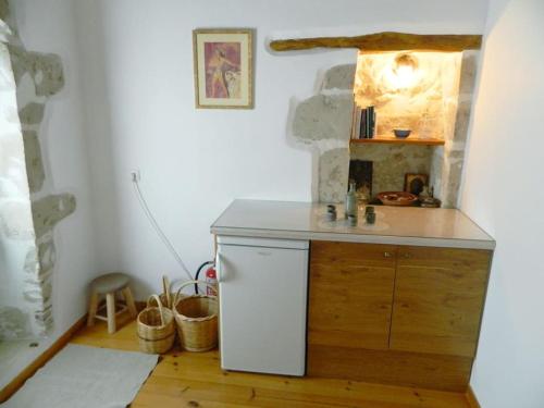 a kitchen with a white refrigerator in a room at Ancient Retreat with 2-Storey Tower Gym Garden in Faneroméni
