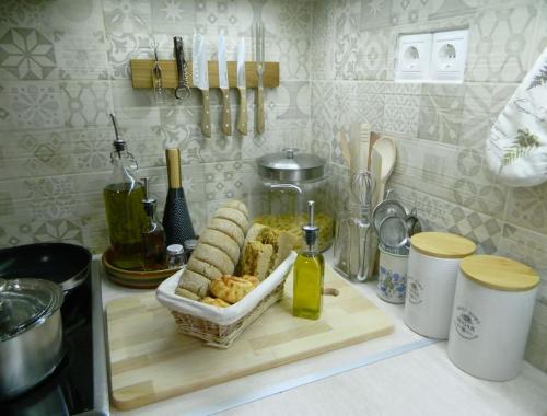 a kitchen counter with a cutting board with food on it at Ancient Retreat with 2-Storey Tower Gym Garden in Faneroméni