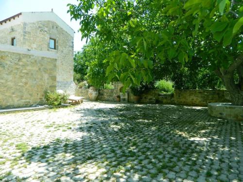 a stone building with a tree in front of it at Ancient Retreat with 2-Storey Tower Gym Garden in Faneroméni