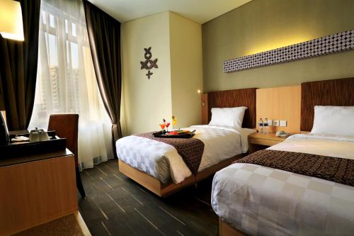 Tempat tidur dalam kamar di Cipta Hotel Pancoran