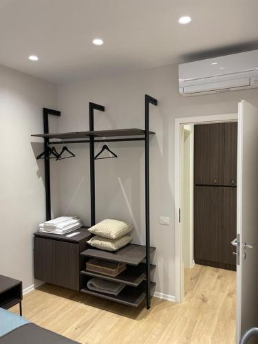 a bedroom with a black shelf with pillows on it at NEW Brilant Apartment in Tirana