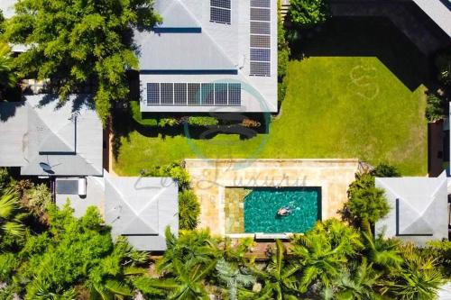 an overhead view of a house with a swimming pool at Zenhouse: 6-BR Balinese Tropical Oasis in Nightcliff Central in Nightcliff