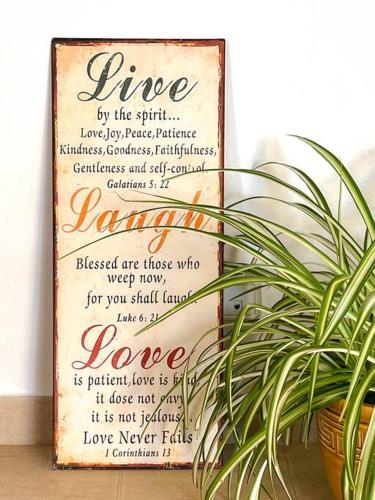 a sign sitting next to a potted plant at Bonita Casa con piscina privada y amplio jardin in Sant Francesc de s'Estany