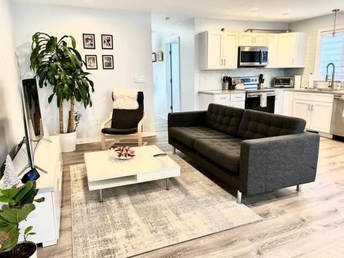 a living room with a couch and a table at Luxury 3BD Condo in the heart of Providence in Providence