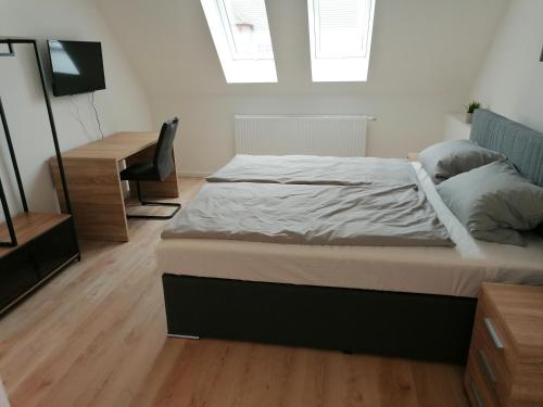 a bedroom with a large bed and a desk at Altes Gesellenhaus in Dinklage