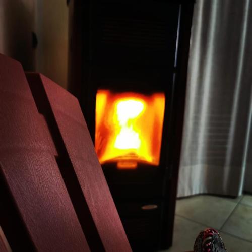 a fire in a stove in a room at Integra apartments in Montalto Uffugo