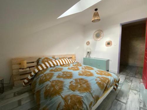 1 dormitorio con 1 cama y reloj en la pared en La chambrette, en Bèze