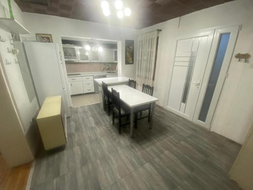 a kitchen with a table and chairs in a room at Iliovski Inn - Just Like Home in Prilep