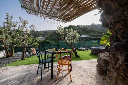 a table and chairs on a patio with a view at Casa rural Bejeque in Teror