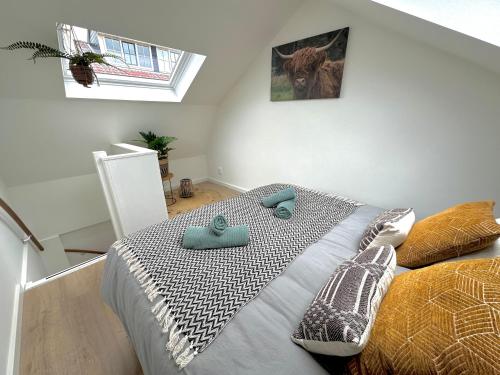 a bedroom with a bed with two pillows on it at Wellness at Sea in Egmond aan Zee