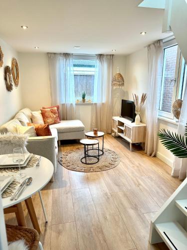 a living room with a couch and a table at Wellness at Sea in Egmond aan Zee
