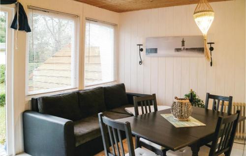a living room with a table and a couch at Two-Bedroom Holiday Home In Middelhagen in Alt Reddevitz