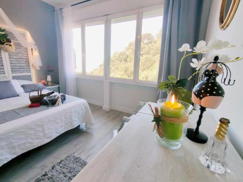 a room with a table with a candle on it at Villa Neptuno in Tossa de Mar