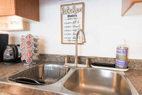 a kitchen counter with a sink in a kitchen at Stylish Boho Retreat- 5 Bed - 4 Bath - 15 min to Falls in Thorold