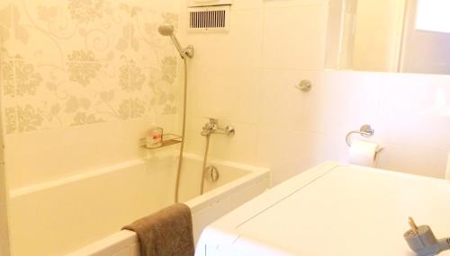 a bathroom with a shower and a tub and a sink at Happy Apartments - Economy in Wrocław