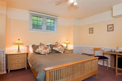 a bedroom with a bed with two tables and two lamps at Cecil Bacon Manor in Seattle