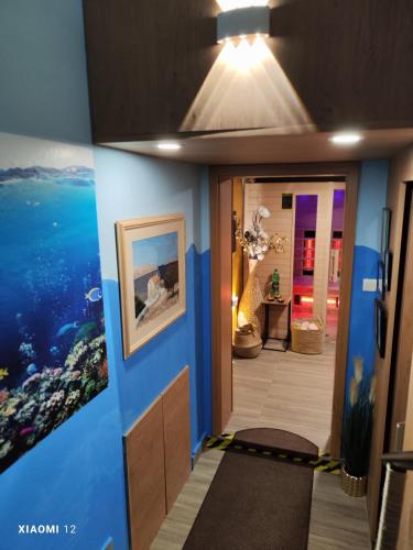 a room with a hallway with blue walls and a meditation room at Snežak (Snowman) 2 in Bohinj