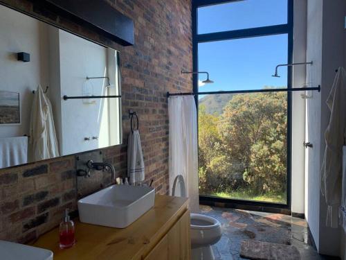 a bathroom with a sink and a large window at Casa Pionono - Sopó in Guasca