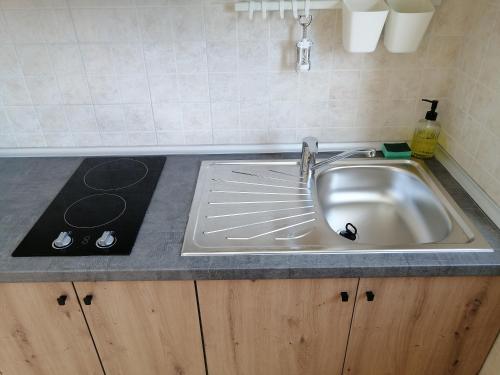 a kitchen counter with a sink and a stove at Apartment Rosanna - Intermezzo in center of Rabac in Rabac
