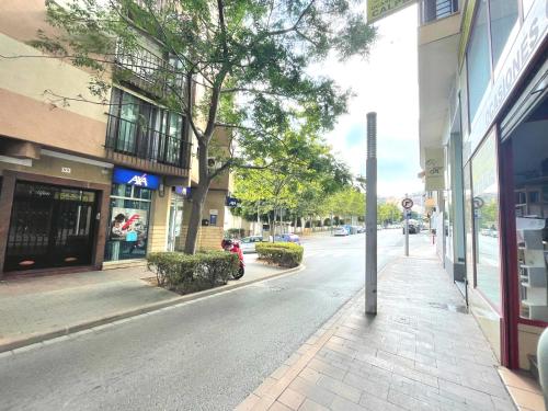 an empty street in a city with buildings at La Linea in Calpe