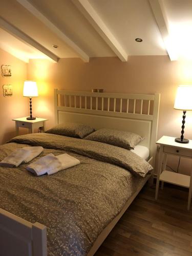 a bedroom with a large bed with two lamps at Eretria’s Villa in Eretria