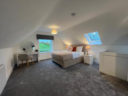 a bedroom with a bed and a desk and a mirror at Country Hideaway in Milltown