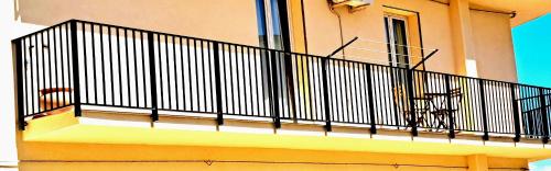 a balcony with a black railing on a building at Appartamento Castel Sant'Angelo in Licata