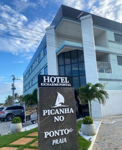 a hotel with a sign in front of a building at HOTEL KICHARME PONTAL in Fortim