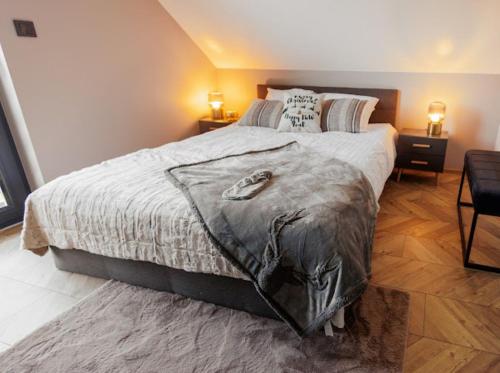 ein Schlafzimmer mit einem Bett mit einer Wolfsdecke darauf in der Unterkunft TRZY SOSNY LOFT APARTMENTS in Ściegny