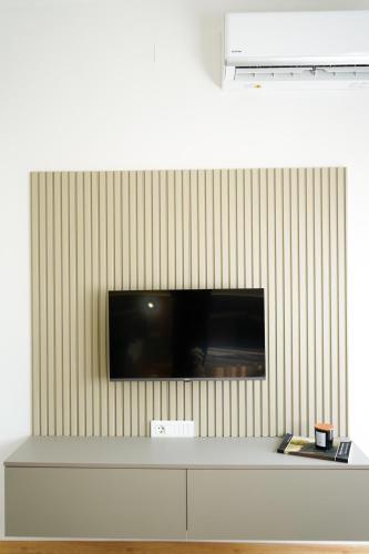 a flat screen tv on a wall at Tolevski Apartments, Bitola in Bitola