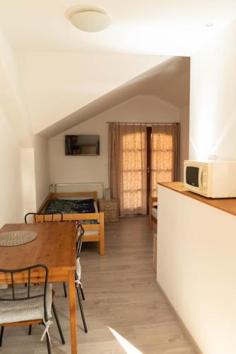 a kitchen and dining room with a table and a microwave at Apartmány Močovice in Močovice