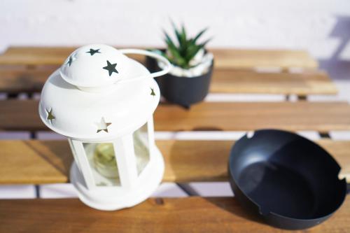 a white vase with stars on it sitting on a table at Tolevski Apartments, Bitola in Bitola