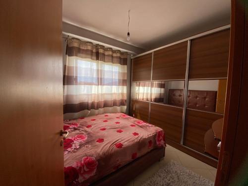 sypialnia z łóżkiem z różowymi kwiatami w obiekcie Sea View Apartment we Wlorze