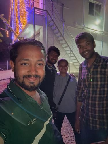 a group of men standing in front of a building at Guru Residency Pondicherry in Puducherry