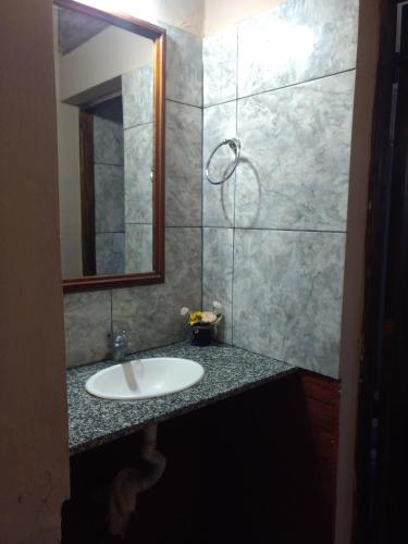 a bathroom with a sink and a mirror at Departamentos Merceditas in San Rafael