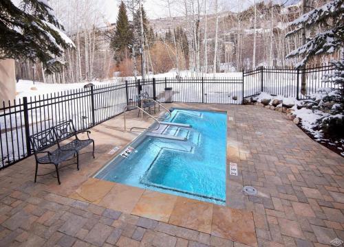 a swimming pool in a yard with a fence at Townsend Place by Vail Realty in Beaver Creek