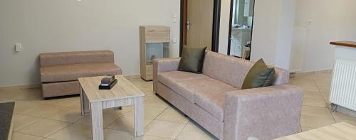 a living room with a couch and a coffee table at Mountainside in Vounoplagiá