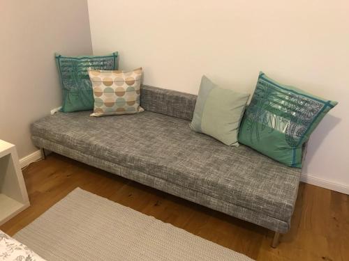 a couch with pillows on it in a room at Aurelia Rooms in Mostar