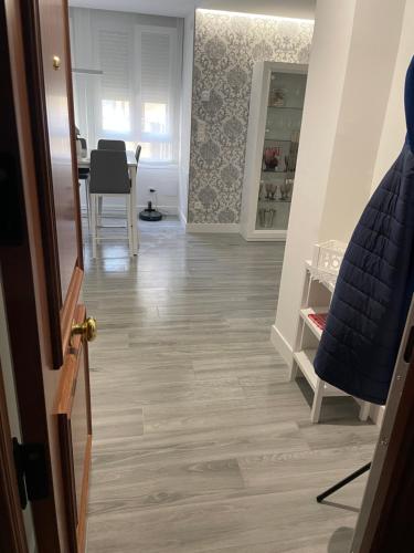 a hallway with a wooden floor and a dining room at Apartamento Maitika in Santander