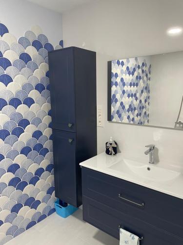a bathroom with a sink and a mirror at Apartamento Maitika in Santander