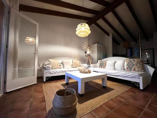 a living room with two white couches and a table at Casa Pueblo Menorquín 49 in Son Xoriguer