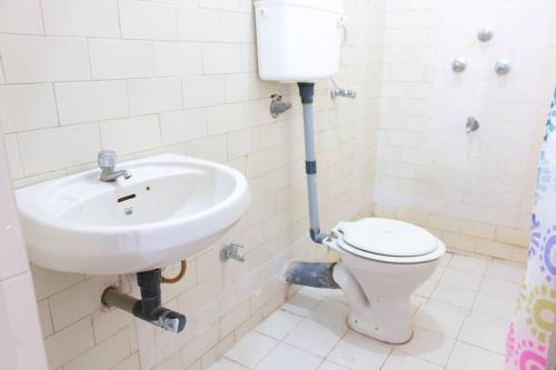 a bathroom with a sink and a toilet at Stay at Colva Beach in Colva