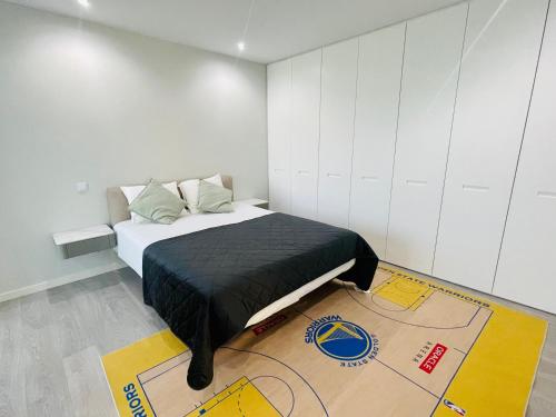 a bedroom with a bed with a map on the floor at rainbow house 