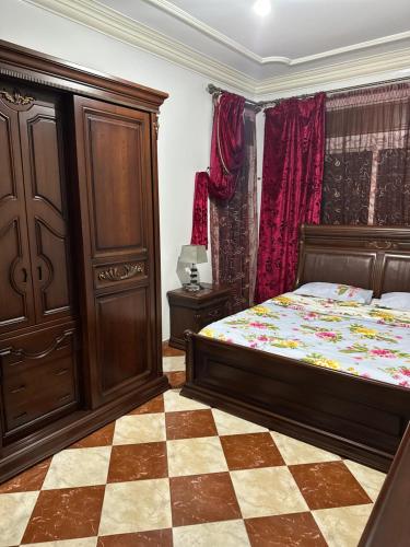 a bedroom with a bed and a dresser at GHIZLAN apartment TETOUAN in Tétouan