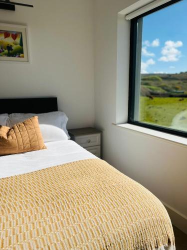a bedroom with a bed and a window at Greene Acres - Room Only in Doolin