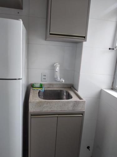 a small kitchen with a sink and a refrigerator at HO1016 in Porto Alegre
